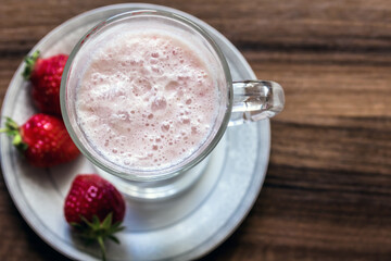  Vegan cocktail. Vitamin Cocktail. Strawberry cocktail on a wooden background close-up.