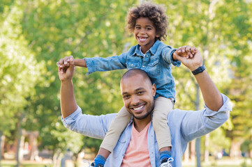 Father giving son piggyback outdoor