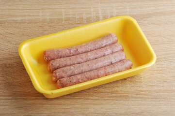 raw meat sausages kupaty in the yellow plastic tray