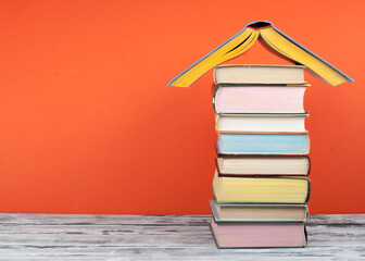 Open book, hardback colorful books on wooden table. Back to school. Copy space for text. Education business concept.