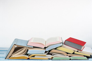 Open book, hardback colorful books on wooden table. Back to school. Copy space for text. Education business concept.