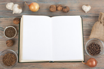 Recipe cook blank book on wooden background, spoon, rolling pin, checkered tablecloth