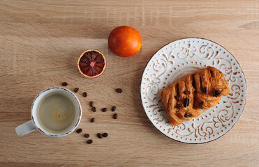 pastry with pecan nuts on a plate with a Cup of coffee