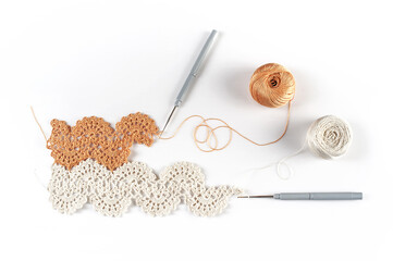 Handmade vintage crochet lace with two ball of threads. Flat lay isolated on white background.