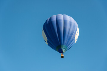 Fototapeta premium Blue air balloon flying in clear sky