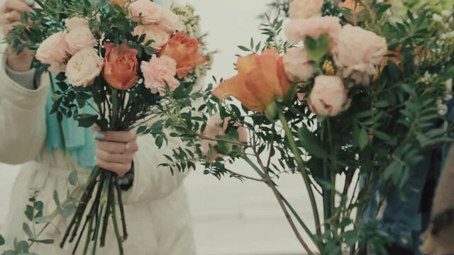 Many beautiful flowers in the bouquet, flower shop, florist girl works on the order, makes a festive bouquet for the customer, fresh flowers, a nice gift for your favorite woman on Mother's Day.