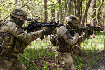 Two soldiers on assault in forest