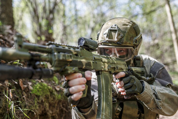 Fototapeta premium Soldier with machine gun, close-up