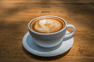 white coffee cup on wood table, coffee time
