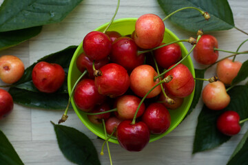 Cherries, fresh and juicy in a small green bowl