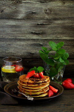 Pancakes with caramel and strawberries for breakfast.