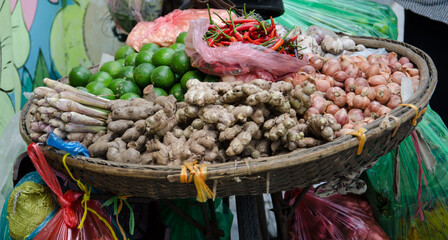 Local market in Vietnam small shop sell fresh spice herb on the street. Lime, Ginger, Grass lemond, Garlic and Chilli.