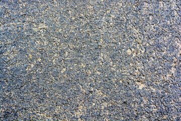 Abstract background of closeup dark uneven asphalt