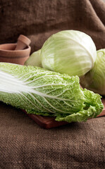 cabbage on a wooden board on a background sacking, burlap