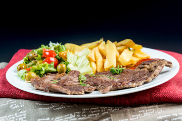 juicy steak beef meat with tomato and french fries