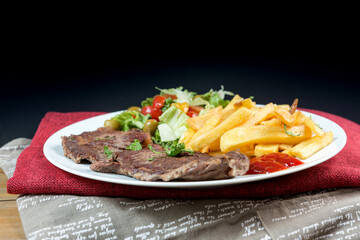 juicy steak beef meat with tomato and french fries