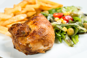 fried chicken and golden French fries potatoes