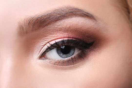 Eye with bright makeup closeup, model face crop