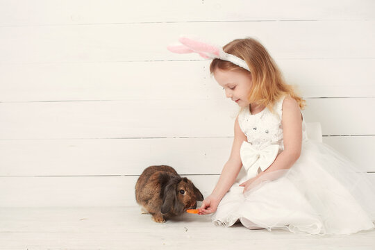 Cute little child girl wearing bunny ears on Easter day.