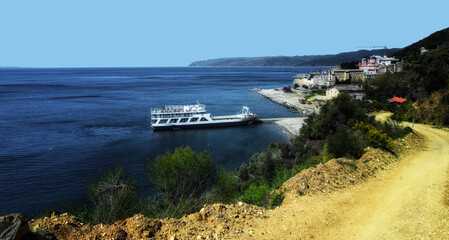 Ferry boat arrives at Mount Athos landscape