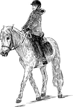 A child is riding a horse
