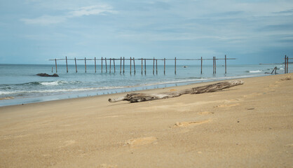 Fototapeta na wymiar Beautiful sand beach and old bridge in Thailand