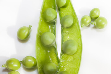 Green peas, close-up on a white background, plate