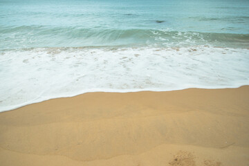 White bubble of sea water on the sand beach