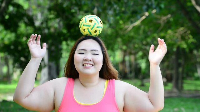 Beautiful woman playing with rattan ball in the park