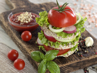 Vegetarian sandwich with vegetables on a wooden board. 