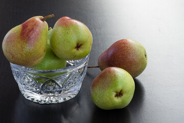 Fresh pears in vase on the brown table. Summer composition.