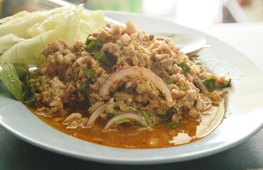 Thai spicy minced pork salad and fresh vegetable on plate