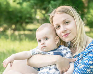 Beautiful happy mather with baby boy outdoor on nature