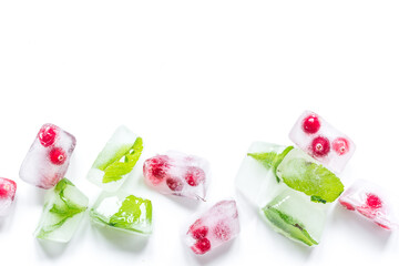 frozen red berries in ice cubes on white background space for text top view
