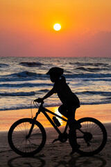 Fototapeta premium People cycling at the beach twilight time