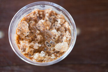 Cold coffee drink with ice on old wood table