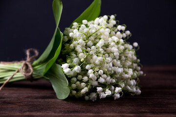 Obraz premium Lily of the valley on wooden background. Lily of the valley bouquet