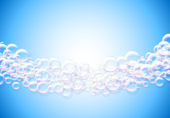 Soap bubbles abstract blue background with rainbow colored airy foam