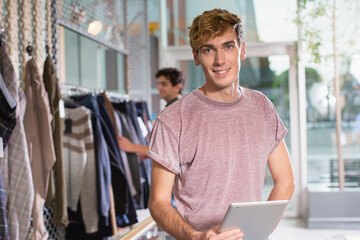 Smiling small business owner holding tablet