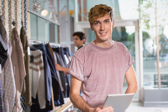Smiling small business owner holding tablet
