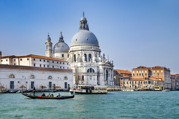 Fototapeta na wymiar Venice Canal. Beautiful Gondola in front of basilica Santa Maria della Salute