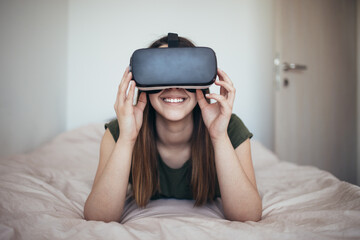 Beautiful young woman enjoying virtual reality at her home. 