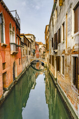 View of the Rio Marin Canal with boats and gondolas from the Ponte de la Bergami in Venice, Italy. Venice is a popular tourist destination of Europe