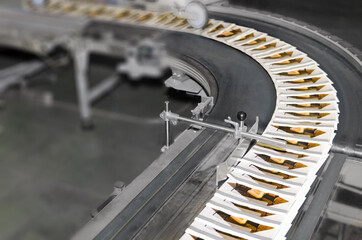Stack of magazines on offset printing machine conveyor belt