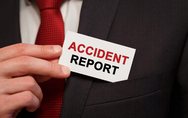 Businessman putting a card with text Accident Report in the pocket