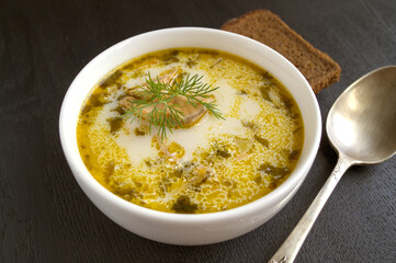 Salmon soup with cream, potatoes, carrots and dill. on a black background.