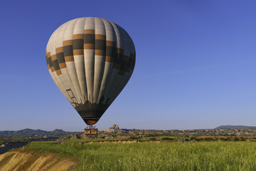 Sunrise in Cappadocia, Turkey, with balloons and typical fairy chimney.