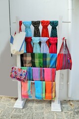 Bunte Schals, Halstücher und Taschen auf Warenständer