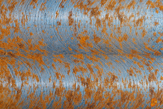 Abstract image of brushed metal covered with rust
