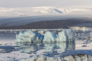 Floating icebergs and Vatnajokull Glacier on the background. Jokulsarlon Glacier Lagoon, Eastern Iceland, Europe